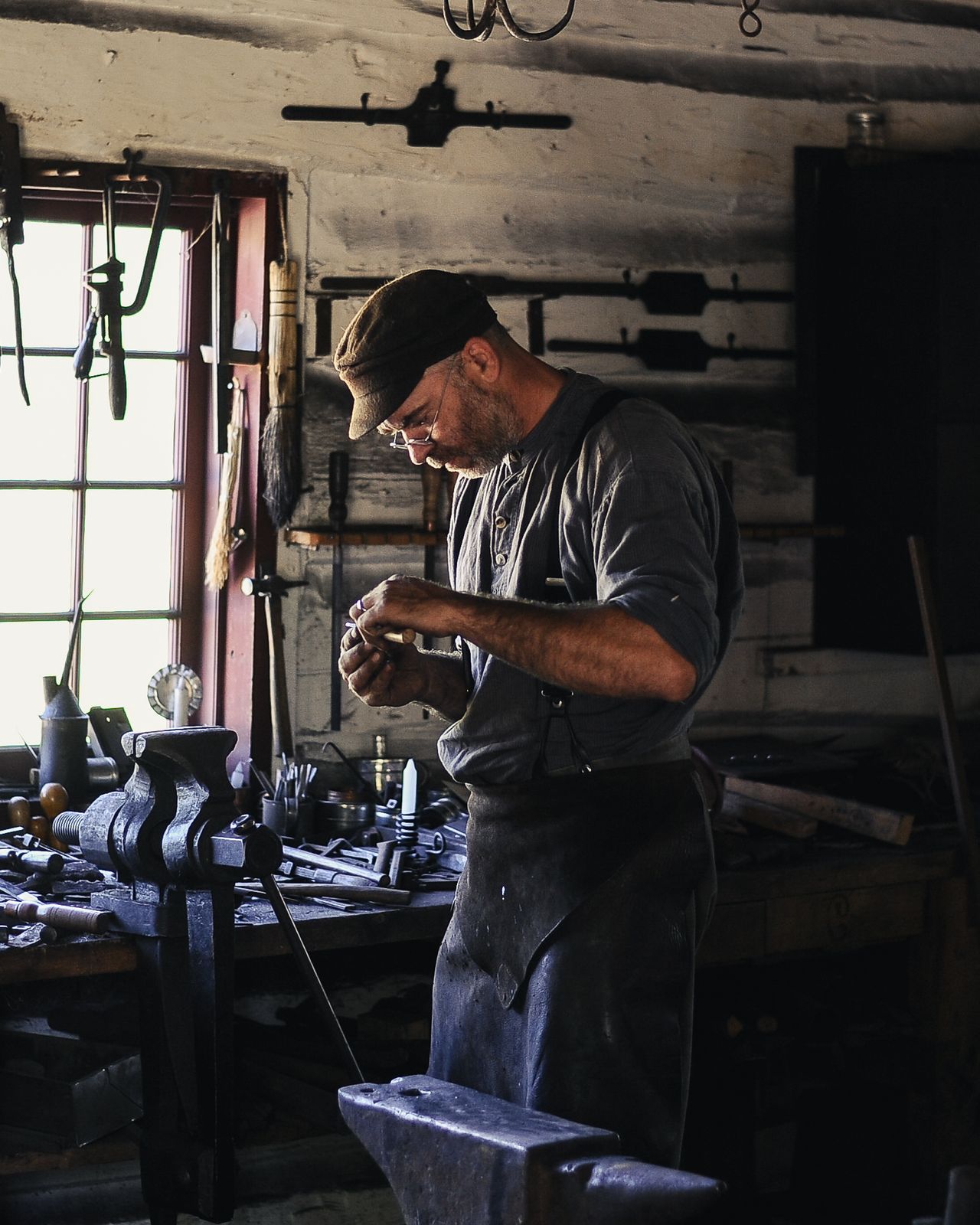 Metalworker at the workbench in a workshop