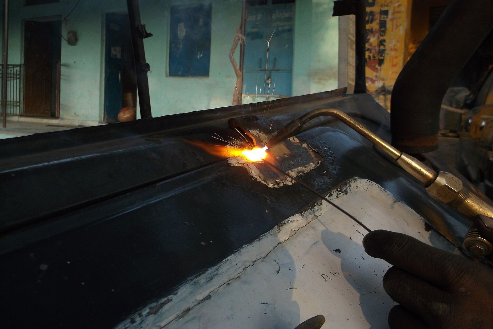 Cutting torch on a steel sheet in production